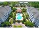 Aerial view of community pool and clubhouse surrounded by buildings and landscaping at 1984 Folly Rd # B114, Charleston, SC 29412