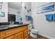 Modern bathroom features a granite countertop, wooden vanity, and elegant mirror with lighting at 1984 Folly Rd # B114, Charleston, SC 29412