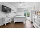Inviting bedroom with ample natural light, white furniture, and a ceiling fan at 1984 Folly Rd # B114, Charleston, SC 29412