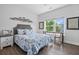 Comfortable bedroom with natural light, ceiling fan, and hardwood floors at 1984 Folly Rd # B114, Charleston, SC 29412