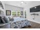 Bright bedroom with large windows, ceiling fan, and TV at 1984 Folly Rd # B114, Charleston, SC 29412