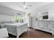 Bright bedroom featuring white furniture, ceiling fan and hardwood flooring at 1984 Folly Rd # B114, Charleston, SC 29412