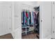 Walk-in closet includes shelving with clothes and shoes for ample storage at 1984 Folly Rd # B114, Charleston, SC 29412