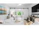 Bright living room with white furniture, barn door to office, and light-filled windows at 1984 Folly Rd # B114, Charleston, SC 29412