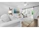 Bright living room features white sofas, ocean artwork, and sliding barn door to the office at 1984 Folly Rd # B114, Charleston, SC 29412