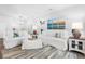 Cozy living room features comfortable white sofas, soft rug, and beach-themed artwork at 1984 Folly Rd # B114, Charleston, SC 29412
