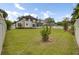 Large backyard with a well-maintained lawn, privacy fence, and the home's exterior, creating an inviting outdoor space at 204 Knightsbridge, Charleston, SC 29418