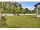 Spacious backyard featuring a white picket fence, lush lawn, and mature trees, perfect for outdoor activities at 204 Knightsbridge, Charleston, SC 29418