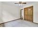 Bedroom featuring a double-door closet, neutral carpet, ceiling fan, and an adjacent room at 204 Knightsbridge, Charleston, SC 29418