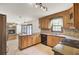 Charming kitchen with wood cabinets, granite countertops, and an adjoining living area at 204 Knightsbridge, Charleston, SC 29418