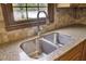 Close-up of a kitchen sink with granite countertops and tile backsplash at 204 Knightsbridge, Charleston, SC 29418