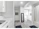 Well-lit bathroom with white cabinets, bathtub, and a convenient laundry area at 205 Tea Farm Rd, Summerville, SC 29483
