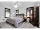 Bright bedroom with a large bed, ceiling fan, and a dark wood armoire at 205 Tea Farm Rd, Summerville, SC 29483