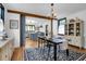 Open dining room with wood floors, modern decor, and a view into a bright kitchen at 205 Tea Farm Rd, Summerville, SC 29483