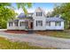 Charming white home with black shutters and a well-maintained gravel driveway at 205 Tea Farm Rd, Summerville, SC 29483