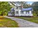 Lovely white house with classic black shutters and landscaped surroundings, set back from the street at 205 Tea Farm Rd, Summerville, SC 29483