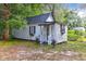 Charming small home with white siding, black roof, and inviting front entrance at 205 Tea Farm Rd, Summerville, SC 29483