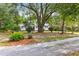 Beautiful tree-lined property with charming home visible from the gravel driveway at 205 Tea Farm Rd, Summerville, SC 29483