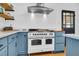 Kitchen features a large oven, quartz countertops, stainless steel hood, and blue cabinets at 205 Tea Farm Rd, Summerville, SC 29483