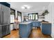 This kitchen features an island, stainless steel refrigerator, and natural light from two windows at 205 Tea Farm Rd, Summerville, SC 29483