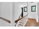 A bright staircase with wood rails and white balusters, leading to the upper level at 205 Tea Farm Rd, Summerville, SC 29483