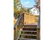Wooden back porch with stairs leading down to the yard, natural wood railings, and home exterior beyond at 2178 Fort Pemberton Dr, Charleston, SC 29412