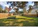 Spacious backyard features a large grassy lawn, mature trees, wooden deck, and gardening beds at 2178 Fort Pemberton Dr, Charleston, SC 29412