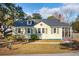 Charming single-story home featuring light yellow siding, dark shutters, and a brick chimney at 2178 Fort Pemberton Dr, Charleston, SC 29412
