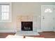 Close-up of the tile fireplace with logs in the living room; next to a window and the front door at 2178 Fort Pemberton Dr, Charleston, SC 29412