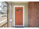 Welcoming orange front door, complemented by brick accents and white trim at 2178 Fort Pemberton Dr, Charleston, SC 29412