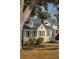 Charming home with sage green siding, complemented by white trim, dormer windows, and mature trees at 2178 Fort Pemberton Dr, Charleston, SC 29412