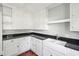 Bright kitchen with white cabinets, black countertops, a stainless steel faucet, and a farmhouse sink at 2178 Fort Pemberton Dr, Charleston, SC 29412