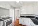 Bright kitchen features white cabinets, black granite countertops, and stainless steel gas range stove at 2178 Fort Pemberton Dr, Charleston, SC 29412
