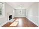 Spacious living room with hardwood floors, fireplace, ceiling fan, and natural light from the window at 2178 Fort Pemberton Dr, Charleston, SC 29412