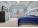 Comfortable bedroom with a tray ceiling, a television, large windows, and a collection of model airplanes at 221 Seaworthy St, Summerville, SC 29486