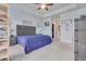 Spacious bedroom with a tray ceiling, a bed, nightstands, airplane decor, and an open doorway to an adjacent room at 221 Seaworthy St, Summerville, SC 29486