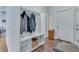 Bright entryway with storage bench, coat hooks, and wood flooring, creating a functional and inviting space at 221 Seaworthy St, Summerville, SC 29486