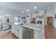 Modern kitchen featuring white cabinets, granite countertops, stainless steel appliances, and hardwood floors at 221 Seaworthy St, Summerville, SC 29486