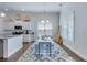 Bright kitchen and dining area, with a large island, stainless steel appliances, and a view of the large windows at 221 Seaworthy St, Summerville, SC 29486