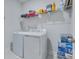 Neat laundry room with washer, dryer, wire rack shelving, and ample storage for cleaning supplies at 221 Seaworthy St, Summerville, SC 29486