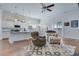 Open-concept living room with hardwood floors and a view of the kitchen and sliding glass doors at 221 Seaworthy St, Summerville, SC 29486
