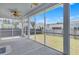 Screened porch offers a view of the backyard and neighboring homes, with ceiling fan at 221 Seaworthy St, Summerville, SC 29486