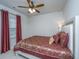 Bedroom with an upholstered headboard, ceiling fan, and a burgundy patterned bedspread at 224 Hayworth Rd, Summerville, SC 29486