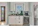 Stylish bar area featuring custom cabinets, marble countertop, wine cooler, and convenient beverage amenities at 2269 Hartfords Bluff Cir, Mount Pleasant, SC 29466