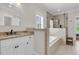 Bright bathroom showcasing a bathtub and an enclosed shower with premium fixtures at 2269 Hartfords Bluff Cir, Mount Pleasant, SC 29466