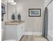 Well-lit bathroom featuring a classic vanity, framed artwork, and a combination shower and tub at 2269 Hartfords Bluff Cir, Mount Pleasant, SC 29466