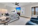 This spacious bedroom features a ceiling fan, a TV, and a decorative rug on hardwood floors at 2269 Hartfords Bluff Cir, Mount Pleasant, SC 29466
