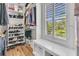 Well-organized closet with wooden floors and natural light streaming through the window at 2269 Hartfords Bluff Cir, Mount Pleasant, SC 29466