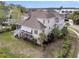 Stunning two-story home with a spacious wraparound porch and lush landscaping, offering serene outdoor living at 2269 Hartfords Bluff Cir, Mount Pleasant, SC 29466