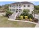 Expansive exterior of this two-story home with lush landscaping and a charming, inviting aesthetic at 2269 Hartfords Bluff Cir, Mount Pleasant, SC 29466